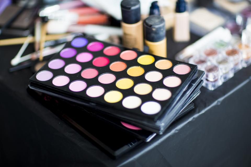 Professional makeup palettes and products arranged on a table